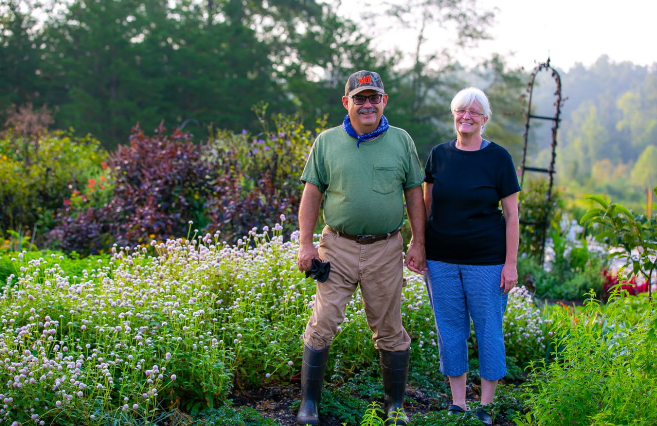 Lis and Tim Murray standing in front of their farm